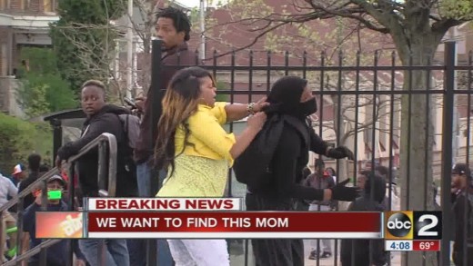Story behind the video: Mom beats son for throwing rocks at police in Baltimore