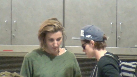Kristen Stewart and Alicia Cargile wait for their bags at LAX Airport